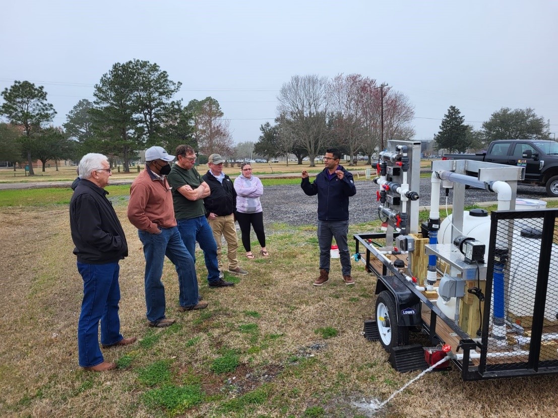 Dr. Adhikari from LSU AgCenter giving a demonstration of different water treatment systems using a mobile water treatment unit. (Photo by Juan Moreira)