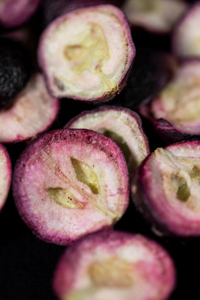 Close up of freeze-dried black muscadine berries were halved and the seeds removed before freeze-drying.