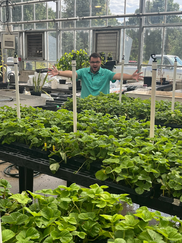 Student in a greenhouse